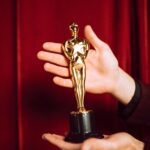 Hollywood award statue on red curtain background