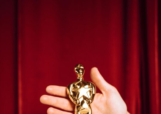 Hollywood award statue on red curtain background