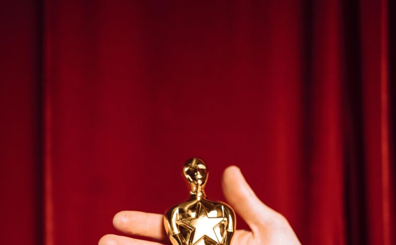 Hollywood award statue on red curtain background