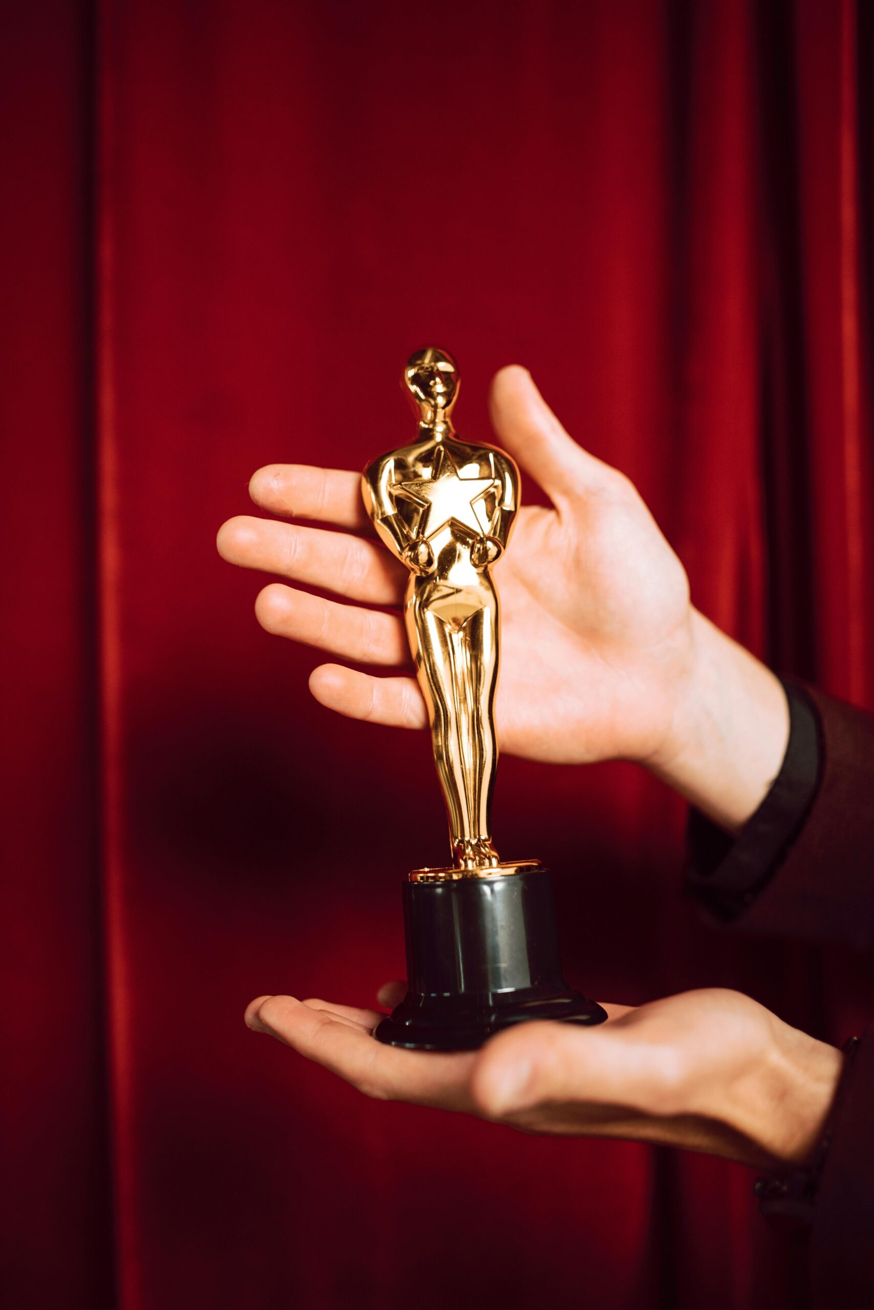 Hollywood award statue on red curtain background