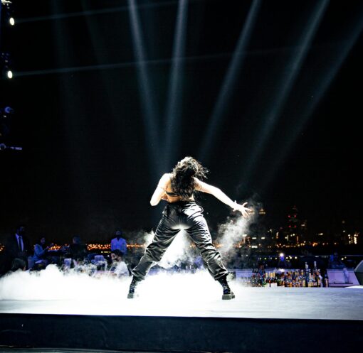 Female pop star performing on stage under bright lights representing Britney Spears concert performance