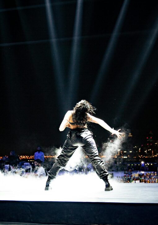 Female pop star performing on stage under bright lights representing Britney Spears concert performance