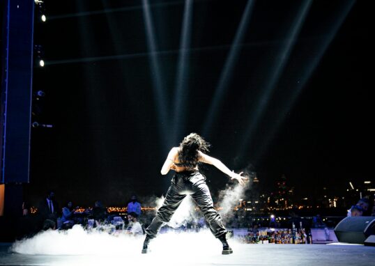 Female pop star performing on stage under bright lights representing Britney Spears concert performance